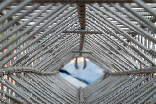 Bild auf Leinwand Geometric Structure of Rebar: An abstract, close-up view of steel rebar forming a diamond-shaped geometric pattern, highlighting the raw structure of construction materials