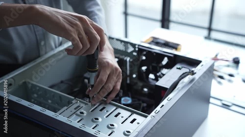 Asian IT engineer using screwdriver fix pc case