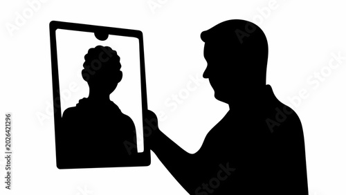Black silhouette of a doctor consulting a patient remotely on a tablet