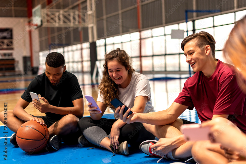 Fototapeta premium Teens enjoying basketball court photo