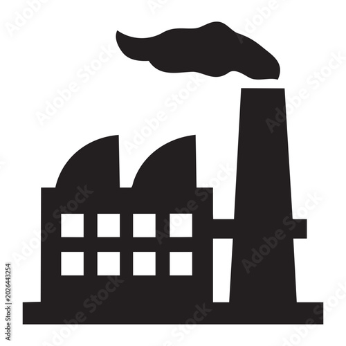 Tableau sur toile A factory emits smoke from its chimney near industrial buildings