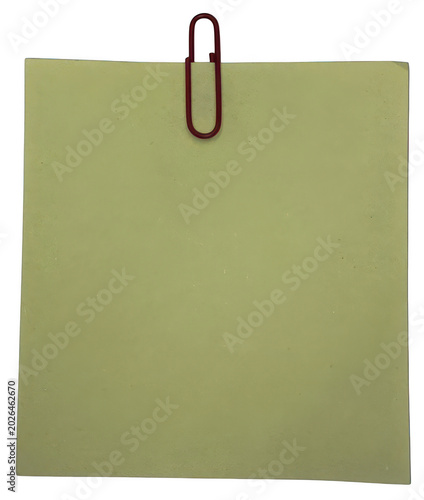 Green sticky note with paperclip attached