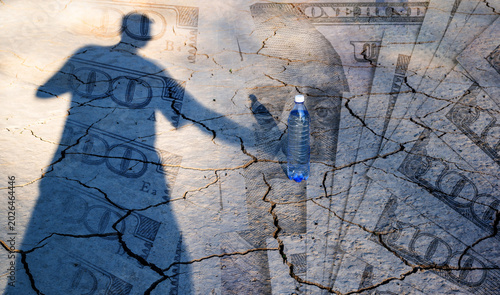 Photography A conceptual story about the lack of drinking water, featuring clay cracked by the heat, a shadow of a person, a bottle of water, and $100 bills