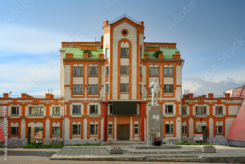 Brick building of the sports complex with a statue of Lenin in Livny, Oryol region of Russia