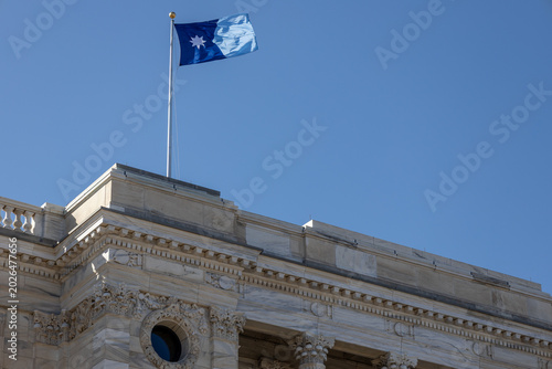 View of the current flag of the state of Minnesota, flying above the State of Minnesota Capitol building roof