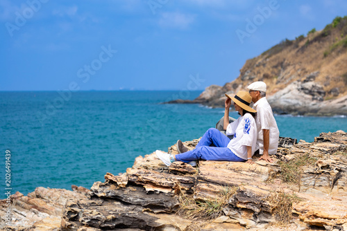 Senior couple enjoy their vacation at the sea beach in summer for healthy relationship and happy loving marriage life in retirement years