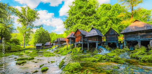 Historic wooden watermills (Mlincici) on the travertine barriers of Plivsko Lake near Jajce, Bosnia and Herzegovina.