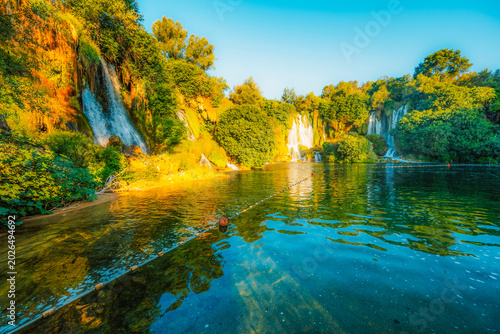 Kravice Waterfalls on the Trebižat River, a natural amphitheater of cascading water and lush green nature near Ljubuški, Bosnia and Herzegovina.