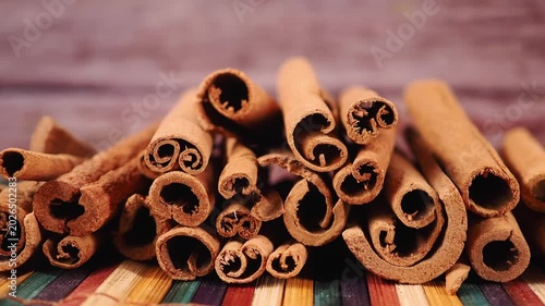 Cinnamon sticks stacked on wooden table for spice lovers