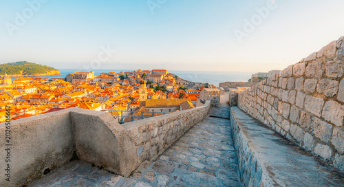 Bild auf Leinwand Golden hour panorama of Dubrovnik's historic fortifications and old port at dusk