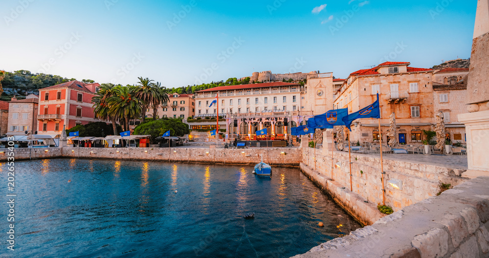 Obraz premium The grand St. Stephen's Square in Hvar town, the Cathedral, the historic Arsenal, and elegant Venetian-style stone architecture, Croatia.