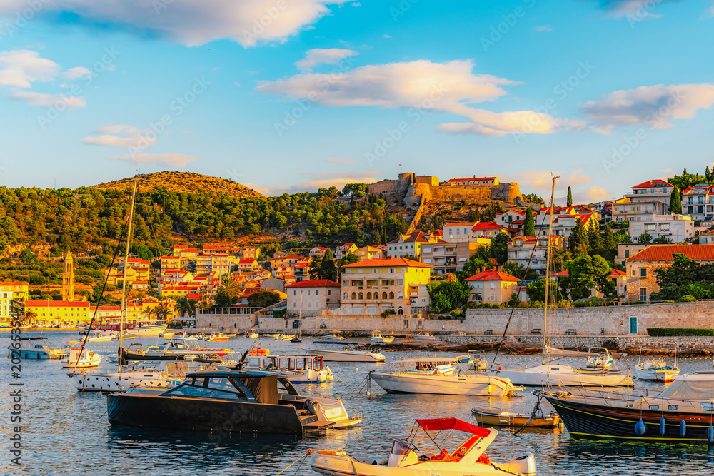 Fototapeta premium Hvar town and Pakleni Islands viewed from the medieval Spanish Fortress, golden hour over the Adriatic sea, Croatia.