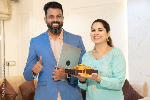Indian woman holding gold jewellerystanding with bank executive or financial agent for secure lending and personal loan, financial assistance, collateral, investment, and consumer banking services.