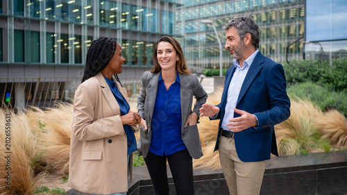 Diverse business people brainstorming ideas during outdoor meeting