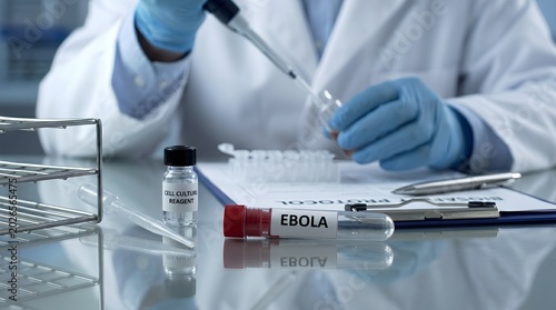 Scientist in lab coat and gloves working with test tubes and pipette in medical laboratory setting with ebola sample