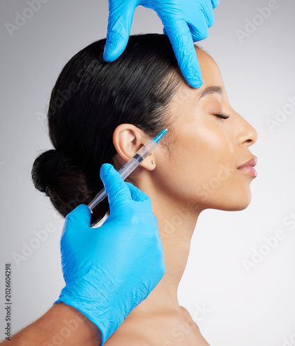 Beauty, studio and woman with syringe for plastic surgery, dermal filler or anti aging treatment. Profile, injection or person with cosmetics for dermatology, change and skincare on white background