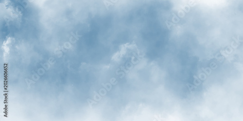 Fotografía Clear blue sky with fluffy white clouds and soft atmospheric texture, bright blue cloudy sky