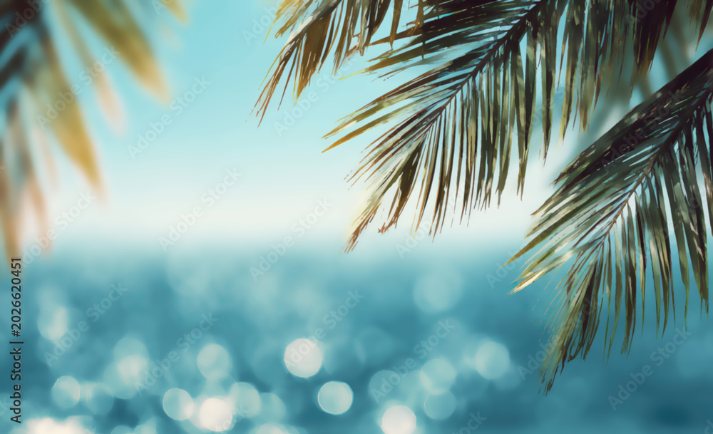 Fototapeta premium Tropical palm fronds frame a shimmering, sun-drenched ocean on a clear day