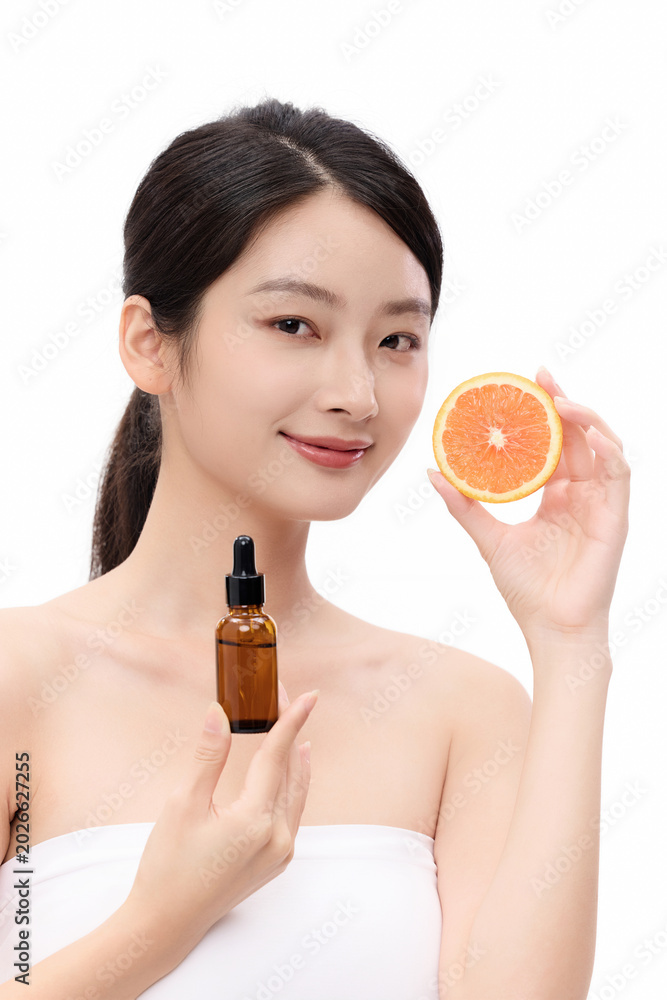 Fototapeta premium Young Woman with Skincare Serum and Orange Slice