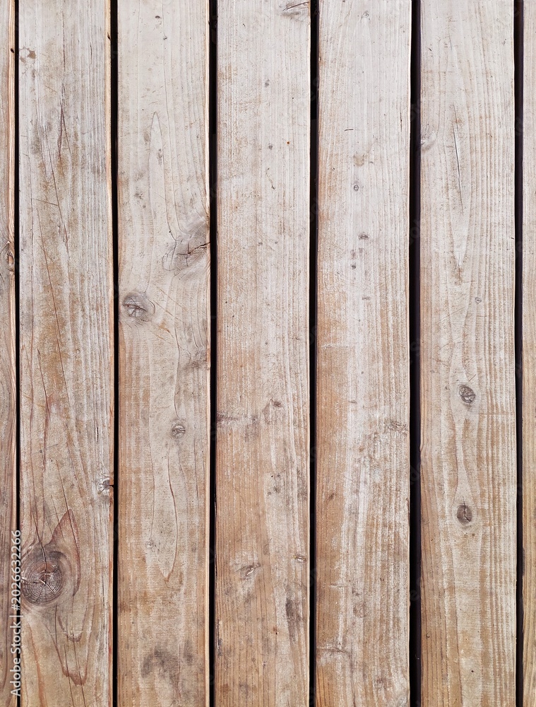 Fototapeta premium High angle view of vintage weathered wooden planks. Natural vertical barn wood boards texture background with knots and scratches. Empty rustic surface for construction, eco or retro design