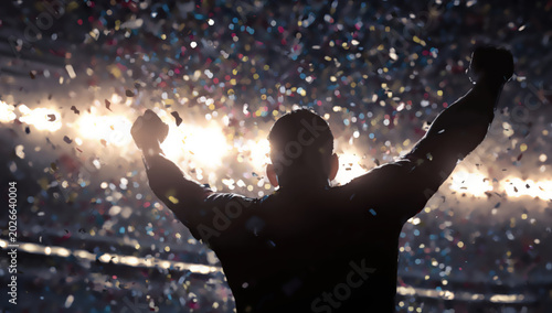 Silhouette of a victorious athlete celebrating under a shower of confetti