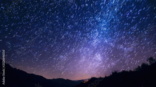 Night sky view featuring countless stars with a silhouetted mountain range