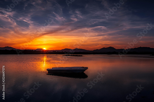 Foto Fishermen''s boats in a bay in the sunset
