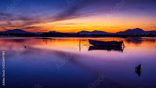 Fishermen''s boats in a bay in the sunset
