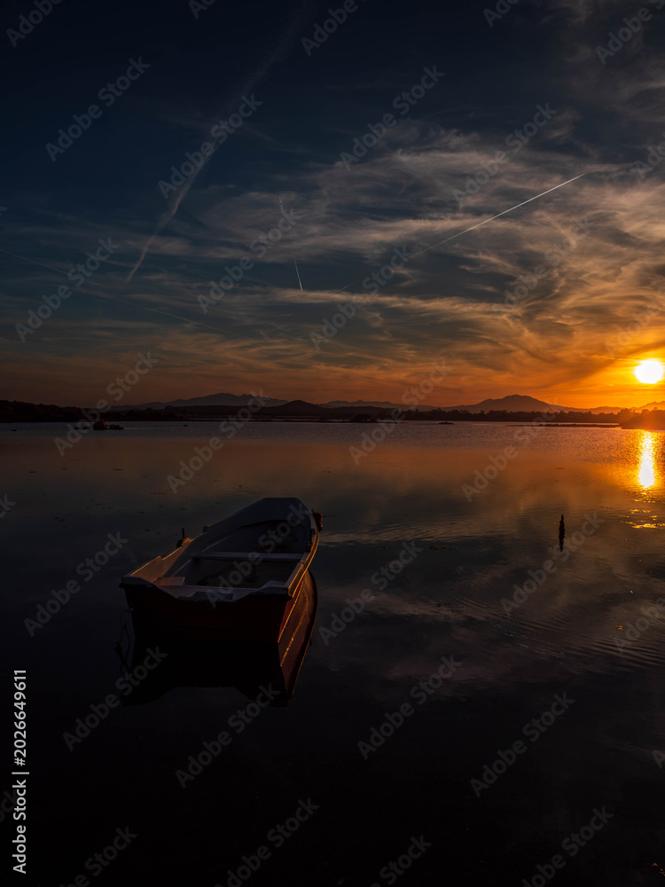 Fototapeta premium Fishermen''s boats in a bay in the sunset