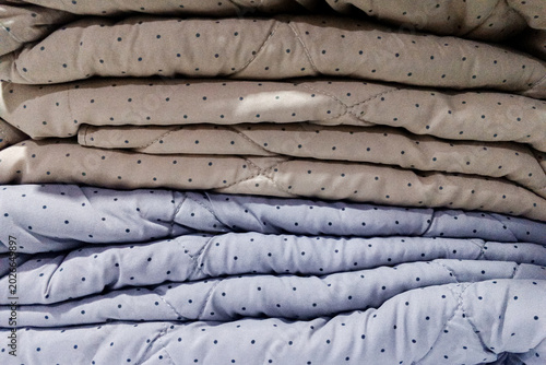 Photos Stack of folded blankets with polka dot pattern arranged neatly indoors