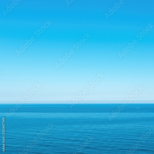 Expansive view of the vibrant blue ocean meeting the clear blue sky on a bright sunny summer day, symbolizing freedom and tranquility ,blue ,tranquility ,nature