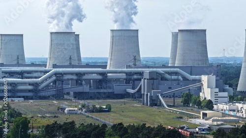 Konstfotografi This high-resolution aerial photograph captures a large thermal power plant with its characteristic hyperbolic cooling towers prominently featured