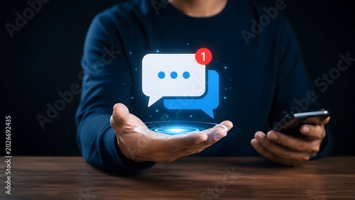 Digital communication concept showing man presenting glowing holographic chat bubble with unread notification badge for modern messaging and social media networking