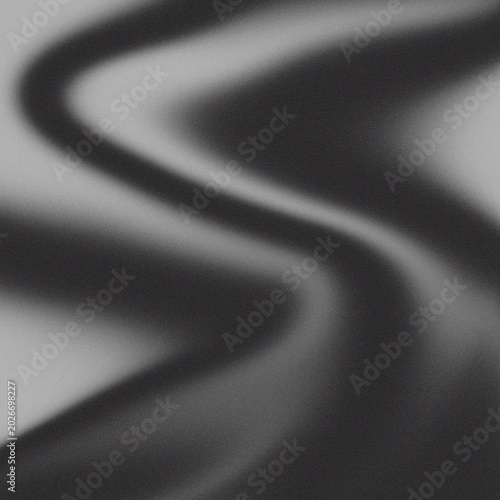 A close-up view of a dark abstract design on a gray background with wavy lines.
