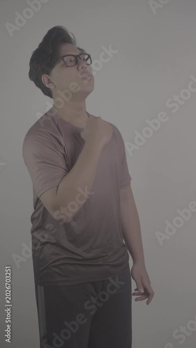 Southeast Asian person wearing brown jersey, raised his clenched fist in excitement, side view S-Log3, S-Gamut3.Cine