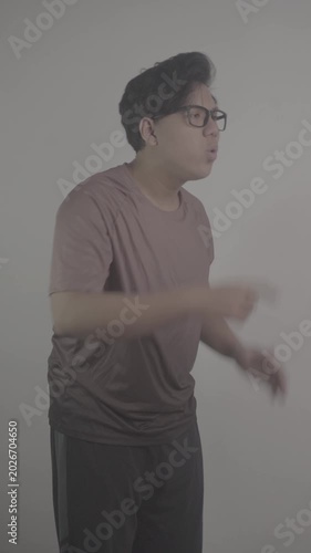 Southeast Asian person wearing brown jersey, with his palms open and his hands cupped around his mouth, shouts loudly, side view S-Log3, S-Gamut3.Cine
