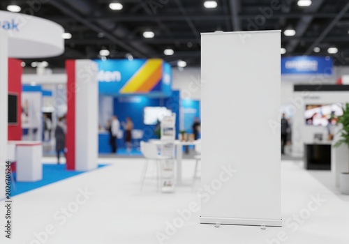 Blank exhibition banner stand in a modern trade show hall with blurred background