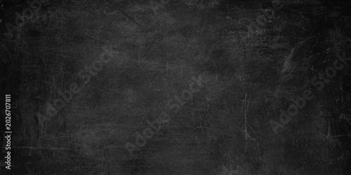 Bild auf Leinwand A dark, textured chalkboard background with subtle scuffs and scratches, perfect for educational or creative projects