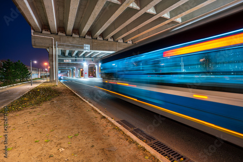 Quadro em tela Nighttime commuting in Chinese cities: Bus drivers under overpasses expose light trails