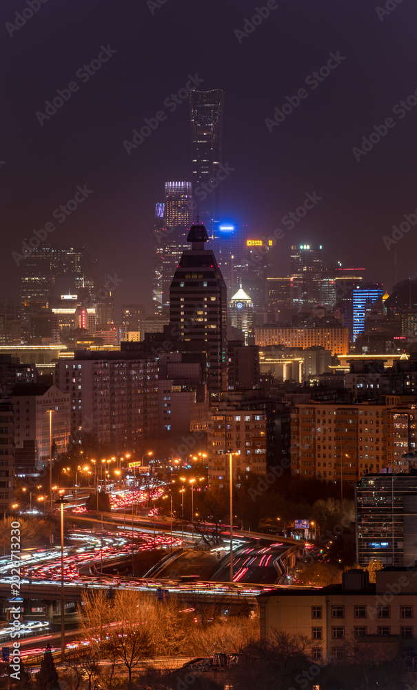 Fototapeta premium Beijing skyline at night, cityscape of skyscrapers, traffic lights and light trails