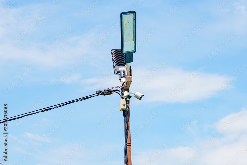 Obraz premium Modern LED Street Lamp and Security Camera on a Pole