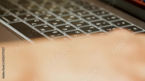 Typing on a dual language laptop keyboard with a silicone cover indoors