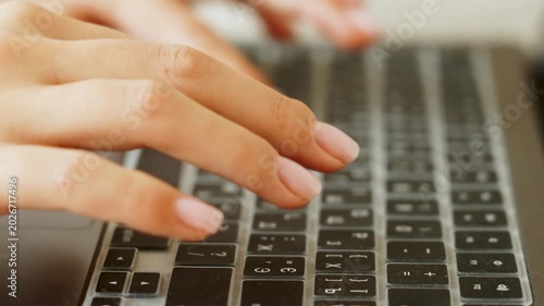 Hands typing on laptop keyboard with clear cover during daytime work session