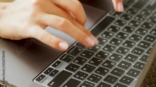 Fingers typing on laptop keyboard with dual language key protector