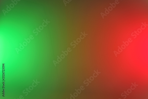 Abstract blurred gradient background featuring bright green and red light flares, soft bokeh tones and smooth color transition, ideal for festive, holiday or modern graphic design and web projects.