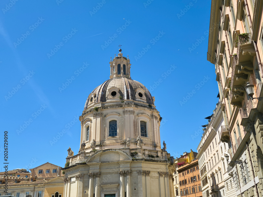 Fototapeta premium Dome of Santissimo Nome di Maria al Foro Traiano Church in Rome Italy Baroque Architecture of Catholic Basilica Cupola Against Blue Sky Vertical View