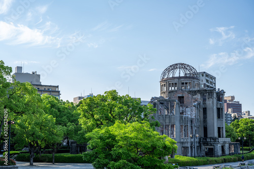 Schilderij op canvas Atomic Bomb Dome Against Blue Sky with Green Trees and Copy Space