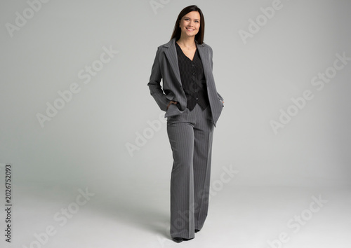 Smiling elegant young business woman. Full body isolated on white background.