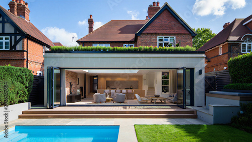 Foto Modern home extension with open plan interior and swimming pool living room bifo