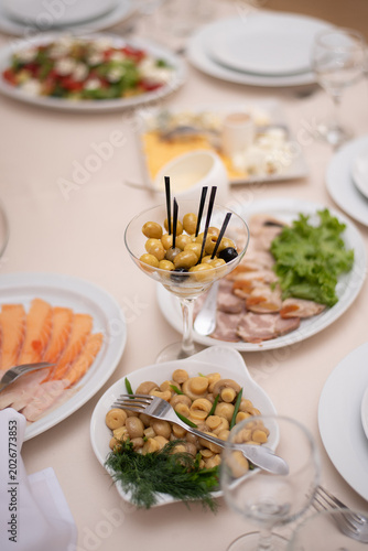 Lots of olives in a glass. Appetizer on a banquet table